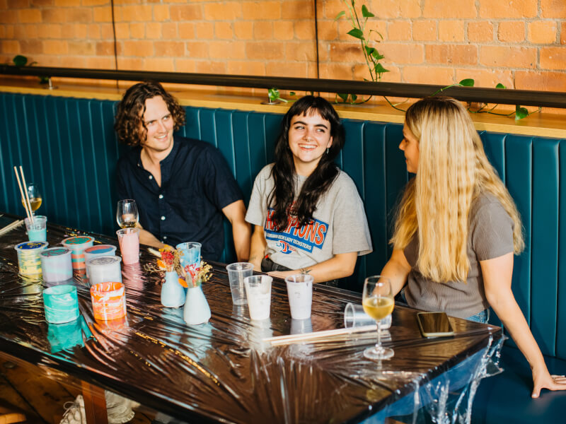 A group of people are smiling during a resin art class 
